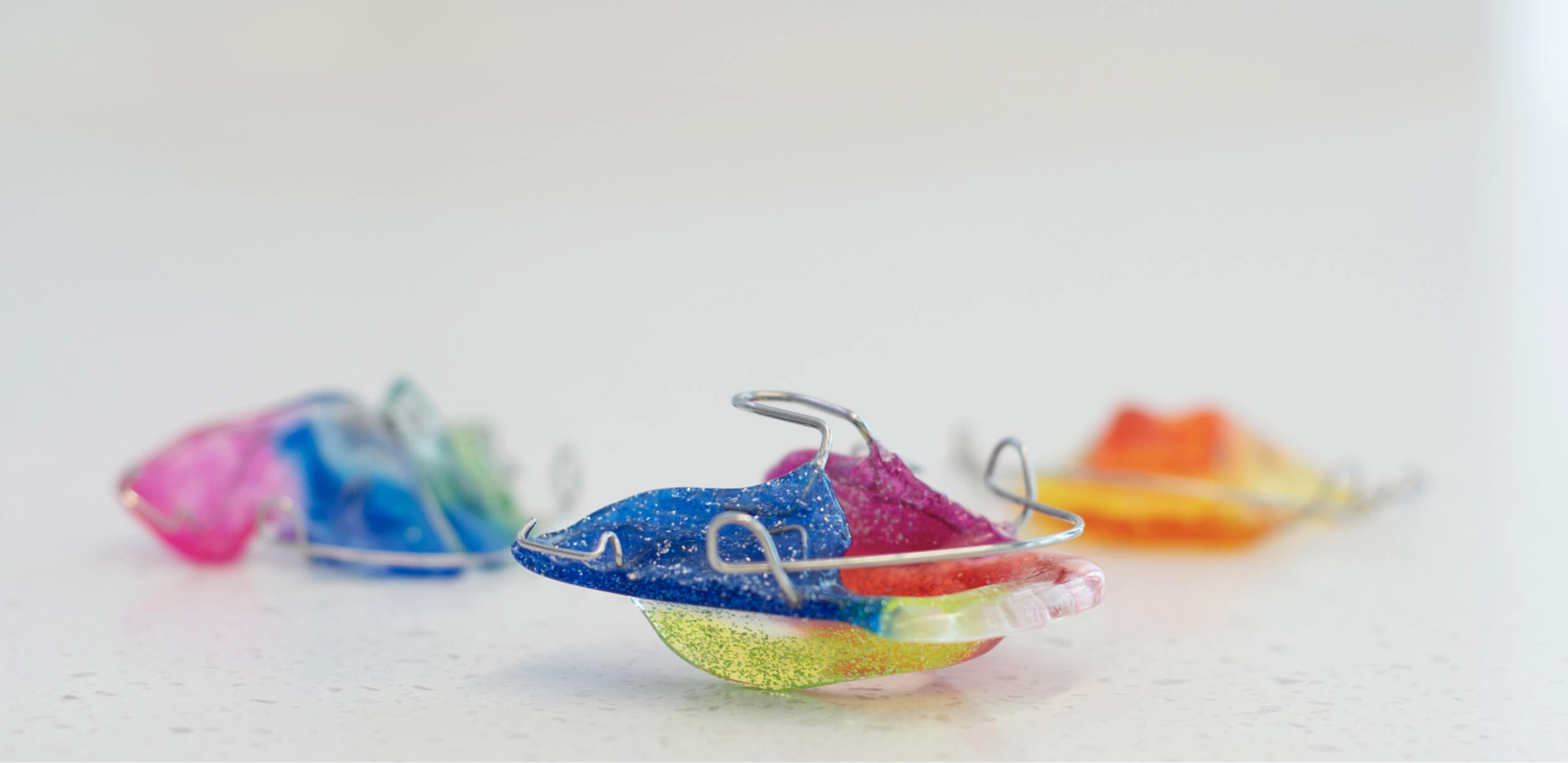 Set of removable orthodontic plates for teeth alignment.